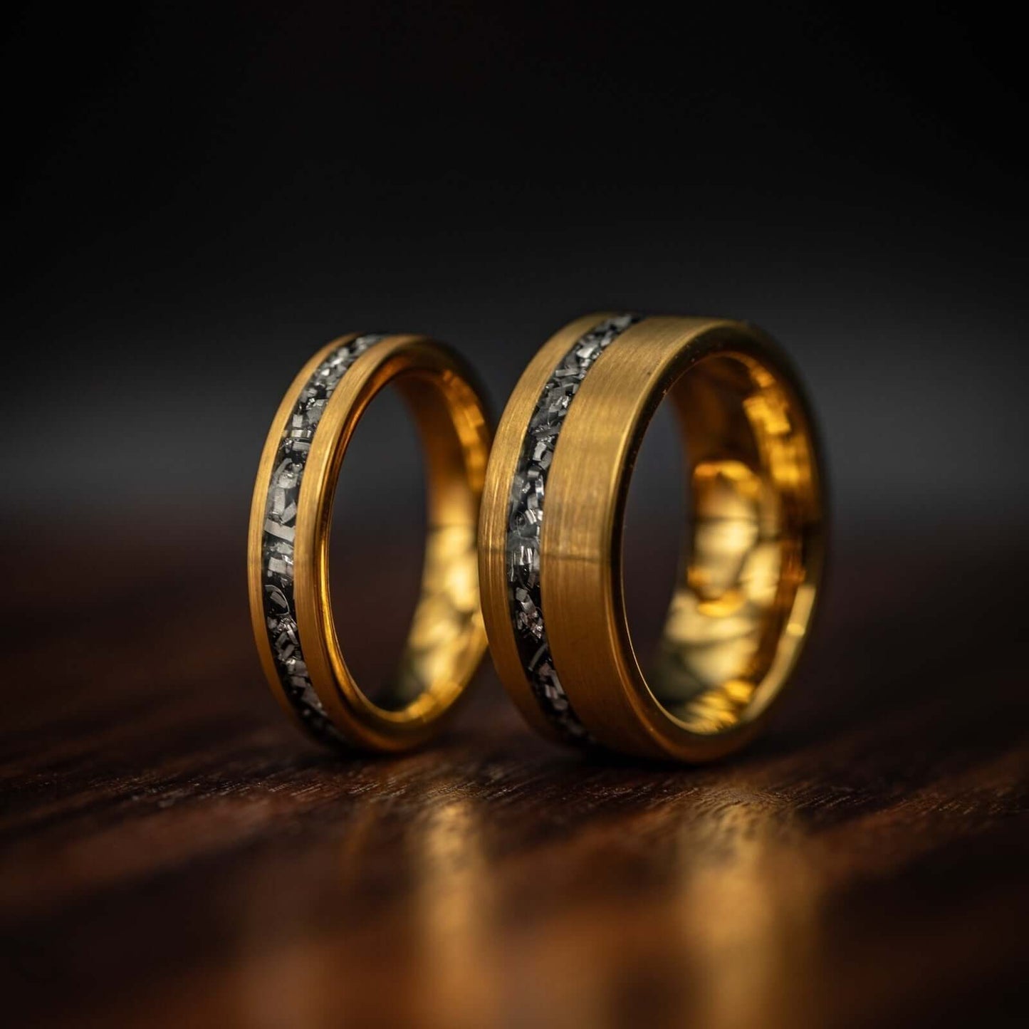 Hi sand hers yellow gold meteorite rings side by side one 8mm and one 4mm