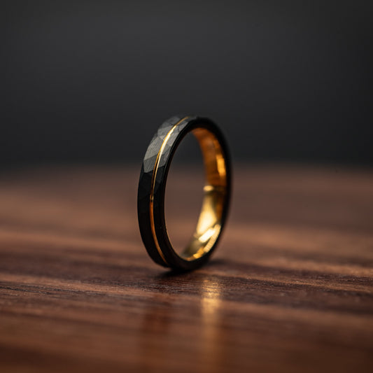 Hammered black wedding ring with yellow gold accent, 4mm width