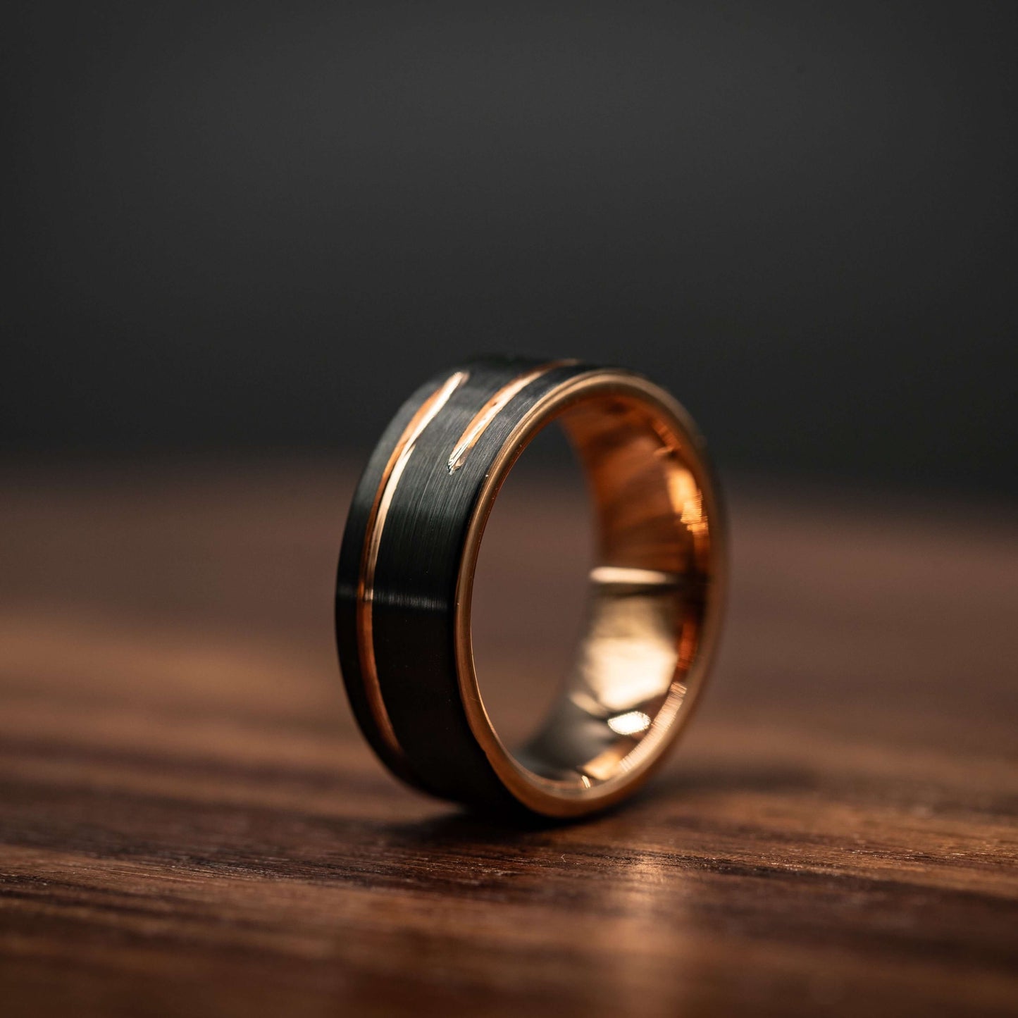 Black and rose gold 8mm tungsten carbide wedding band, unique men's ring with offset inlay design.