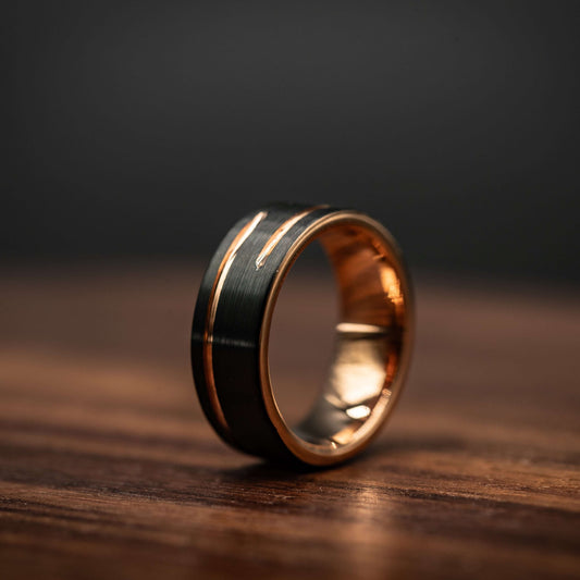 Black and rose gold 8mm tungsten carbide wedding band, unique men's ring with offset inlay design.