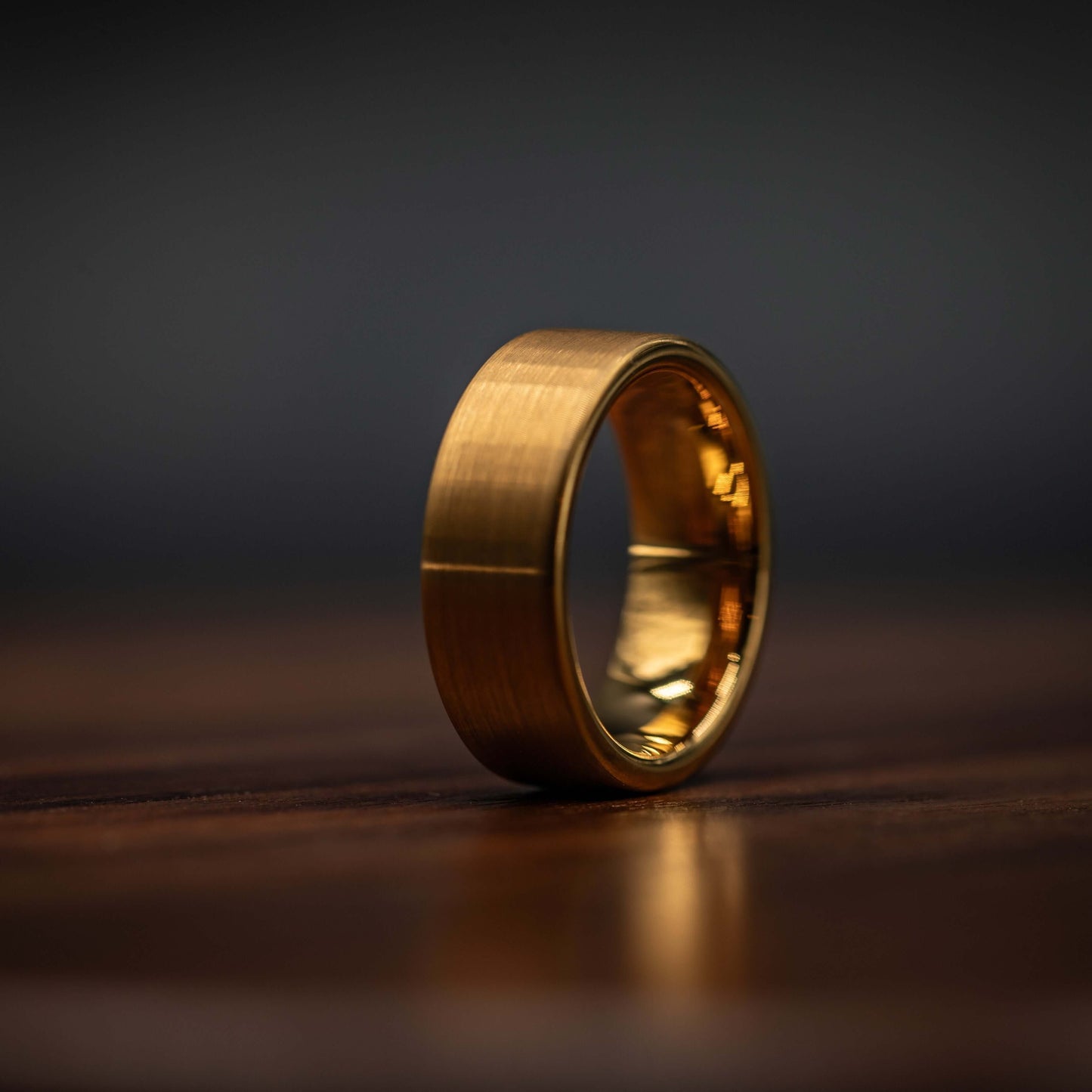 Gold brushed tungsten wedding band side view, showcasing its unique yellow gold finish and durable design.