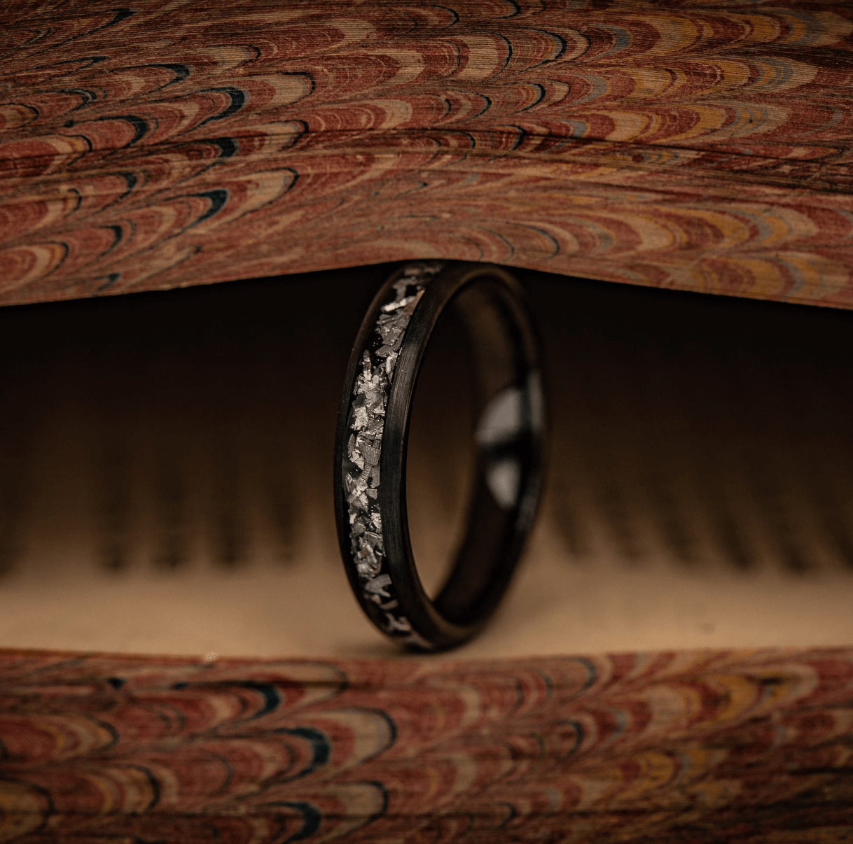 Women's black brushed meteorite wedding ring, a stunning choice for engagements.
