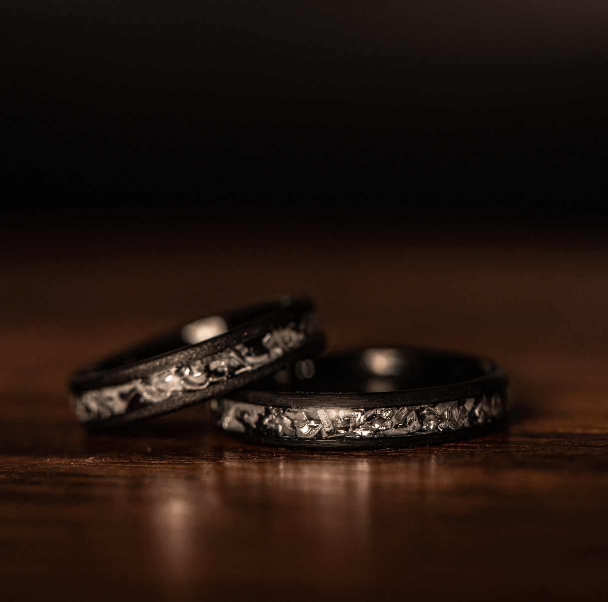 Contemporary women's wedding band crafted from black brushed meteorite, symbolizing everlasting love.