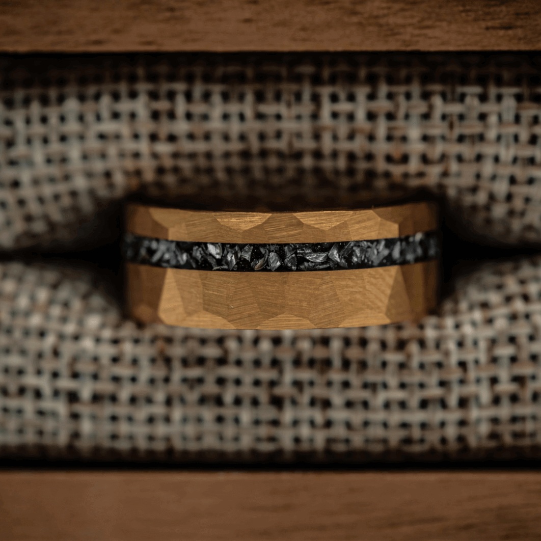 Yellow gold ring with hammered texture and meteorite in ring box