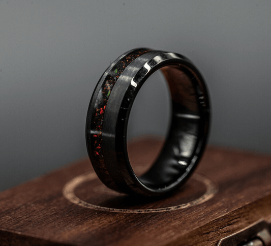 Black brushed tungsten ring with a channel of black fire opal, showcasing modern elegance and durability.