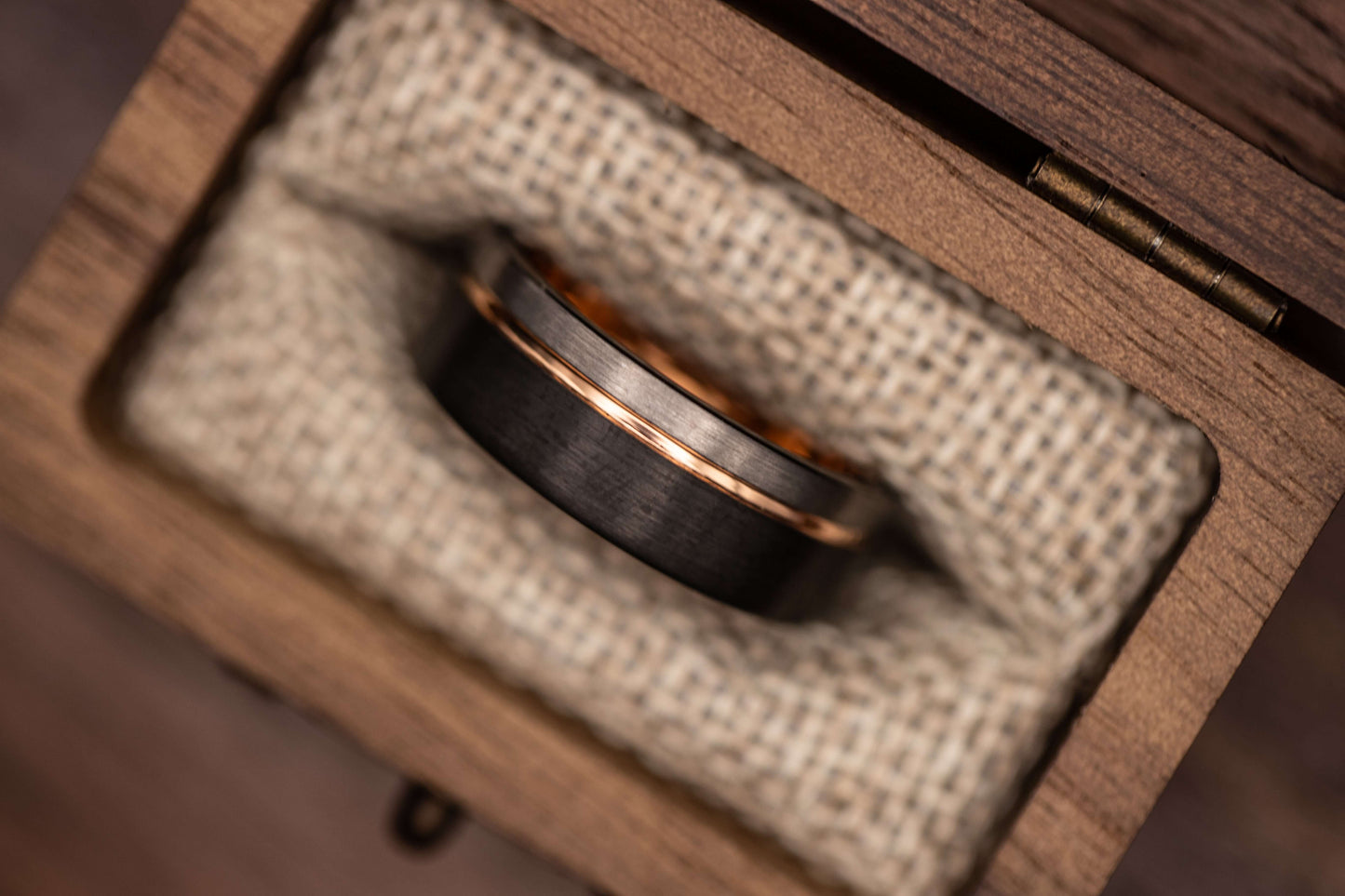 Black and Silver Wedding Ring with Rose Gold inlay in a wooden box