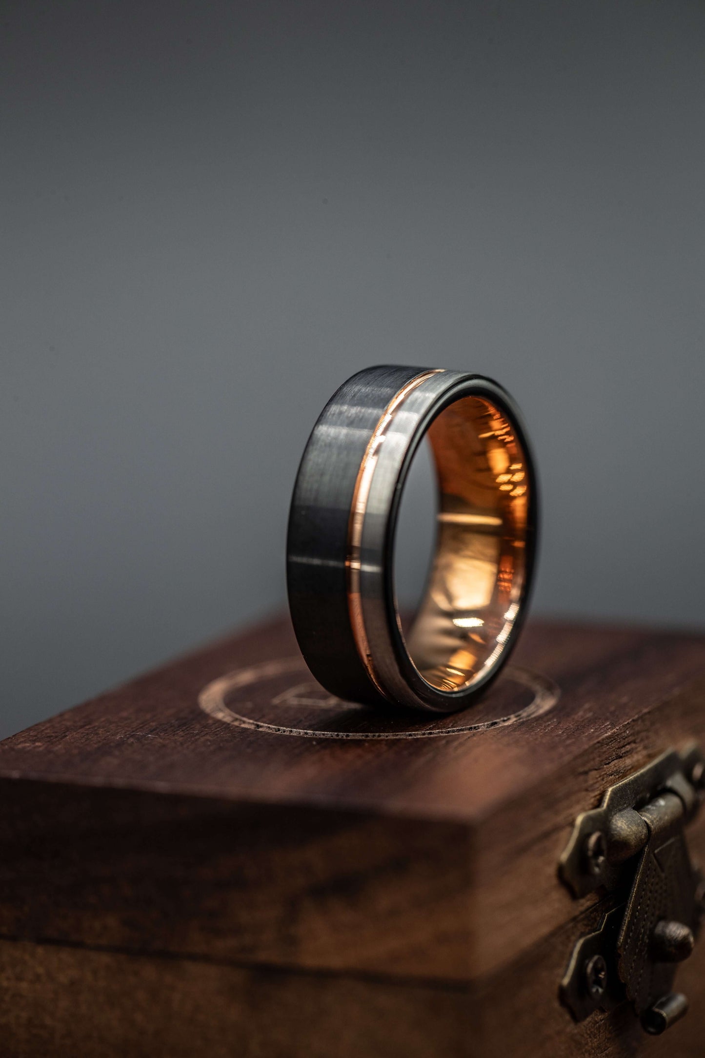Black and silver wedding ring with rose gold inlay, men's wedding band, unique hammered rose gold engagement ring on wooden box