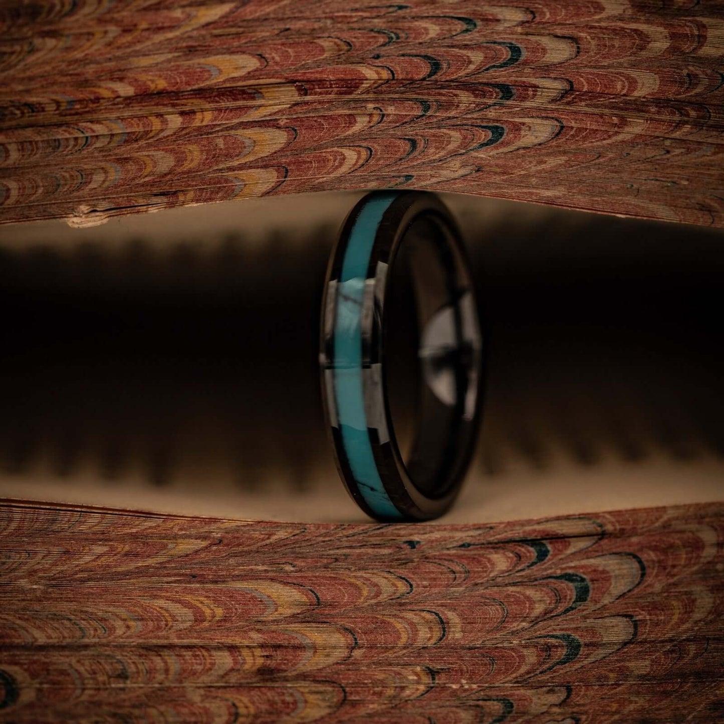 Couples wedding bands with vibrant turquoise and sleek black details.