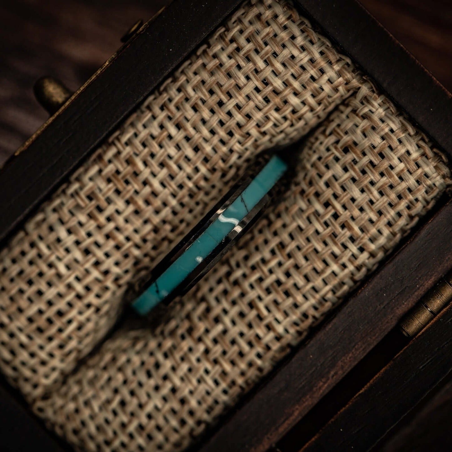 Unique turquoise and black wedding bands for couples, showcasing modern elegance.