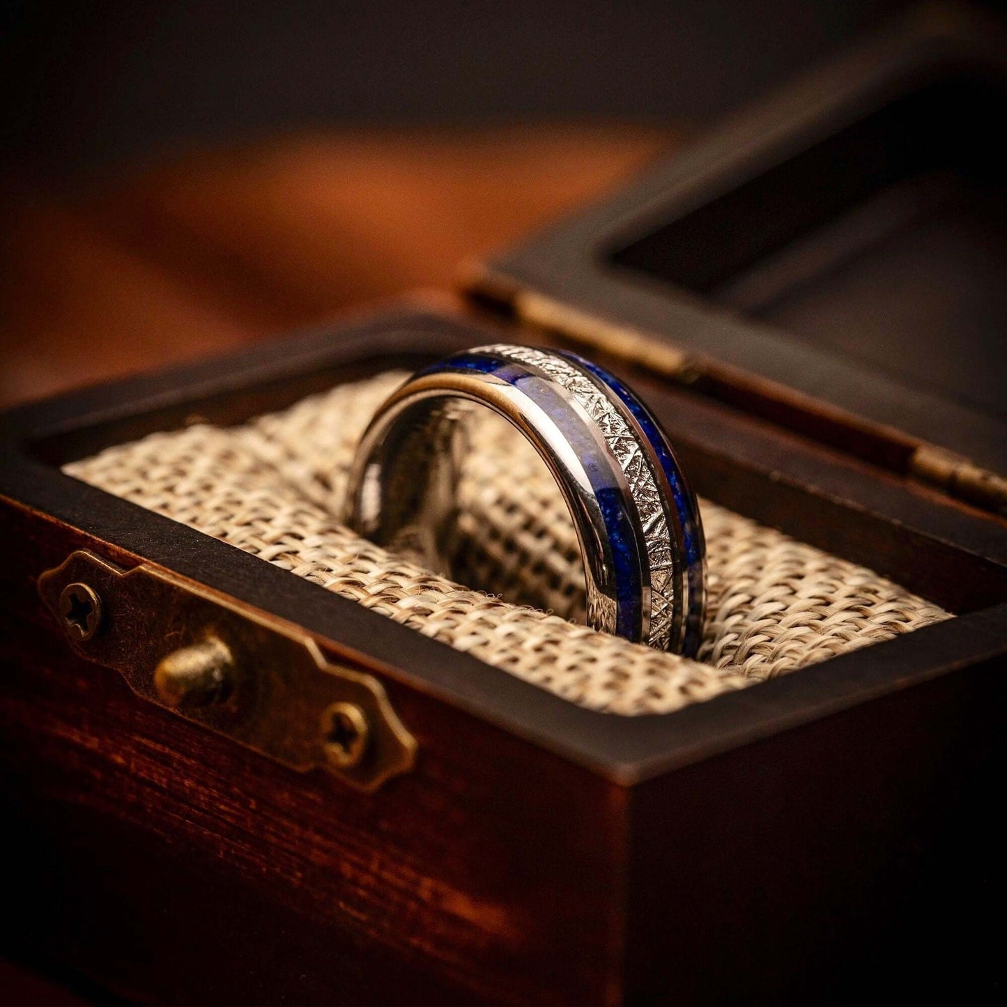 Stylish men's wedding band showcasing silver, blue lapis lazuli, and real meteorite.