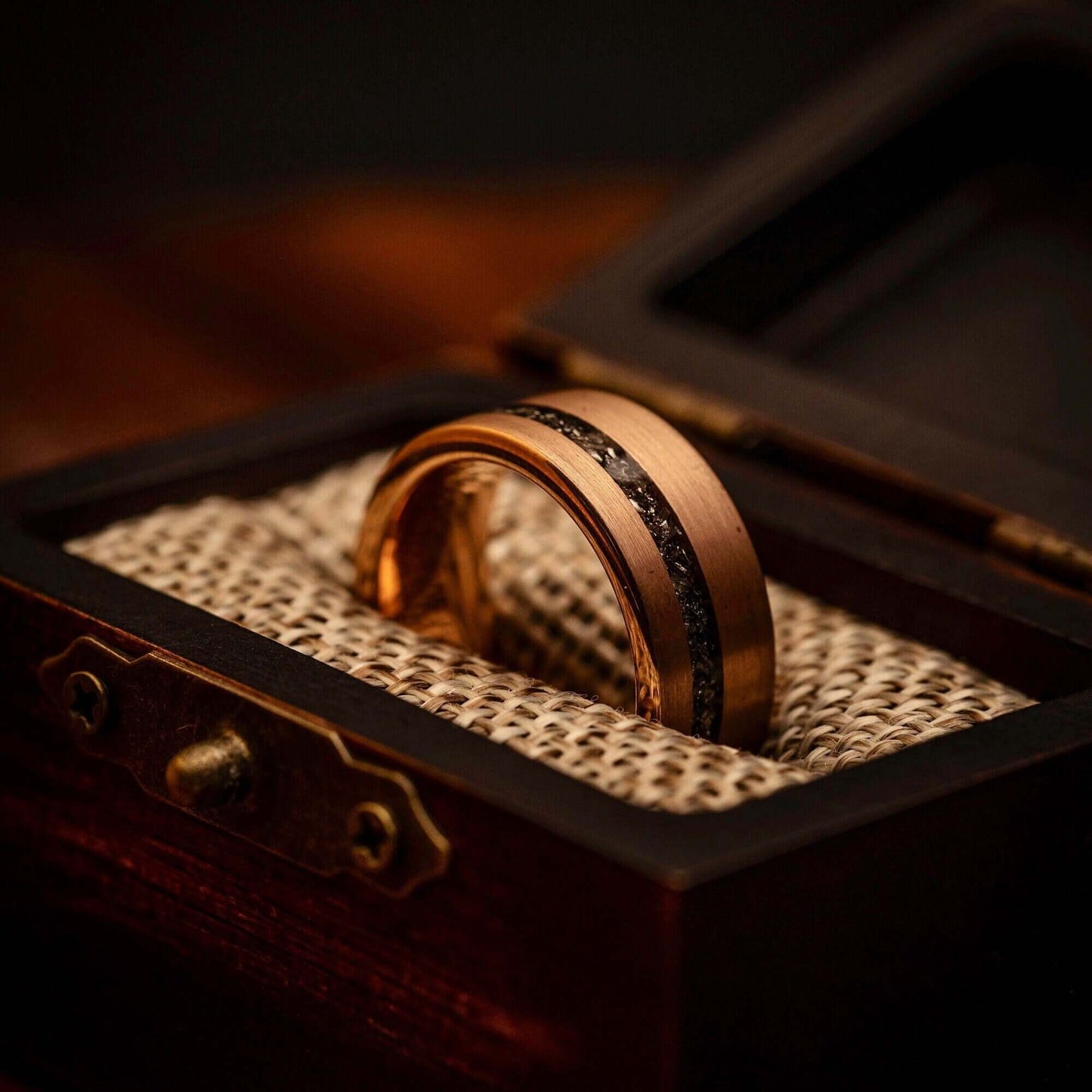 Distinctive rose gold wedding ring with genuine meteorite inlay, symbolizing eternal love.