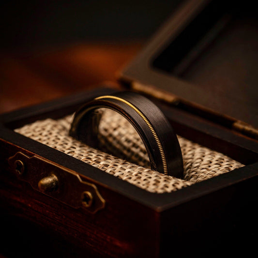 Black Wedding ring with Yellow Gold Guitar String inlay inside walnut ring box