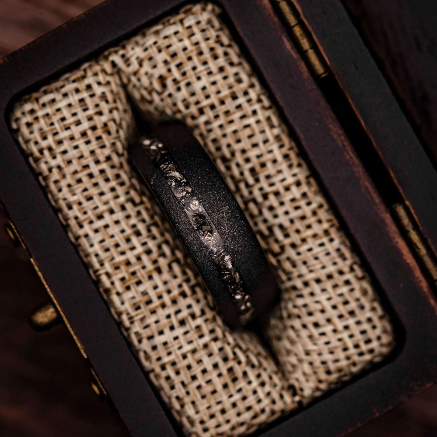 Stylish black tungsten ring with genuine meteorite, perfect for weddings or engagements.