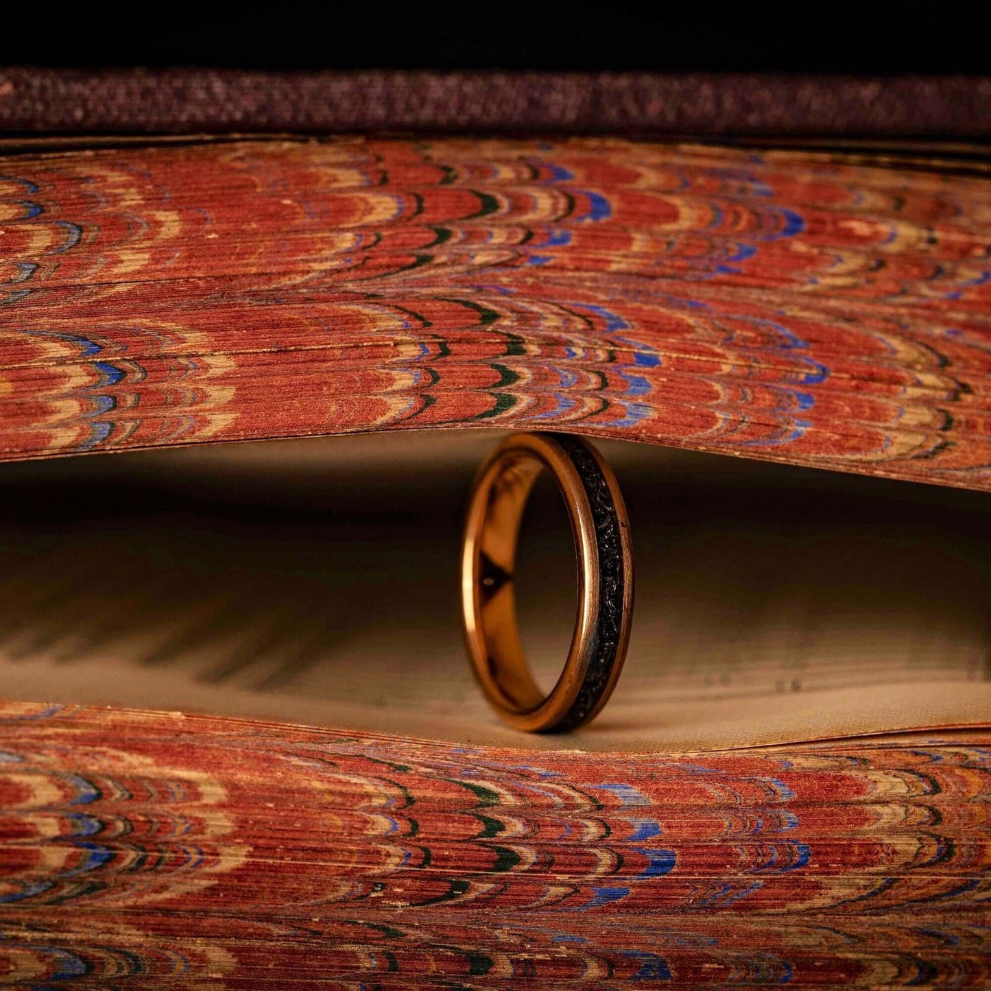 Striking women's wedding band with rose gold and genuine meteorite, symbolizing eternal love.