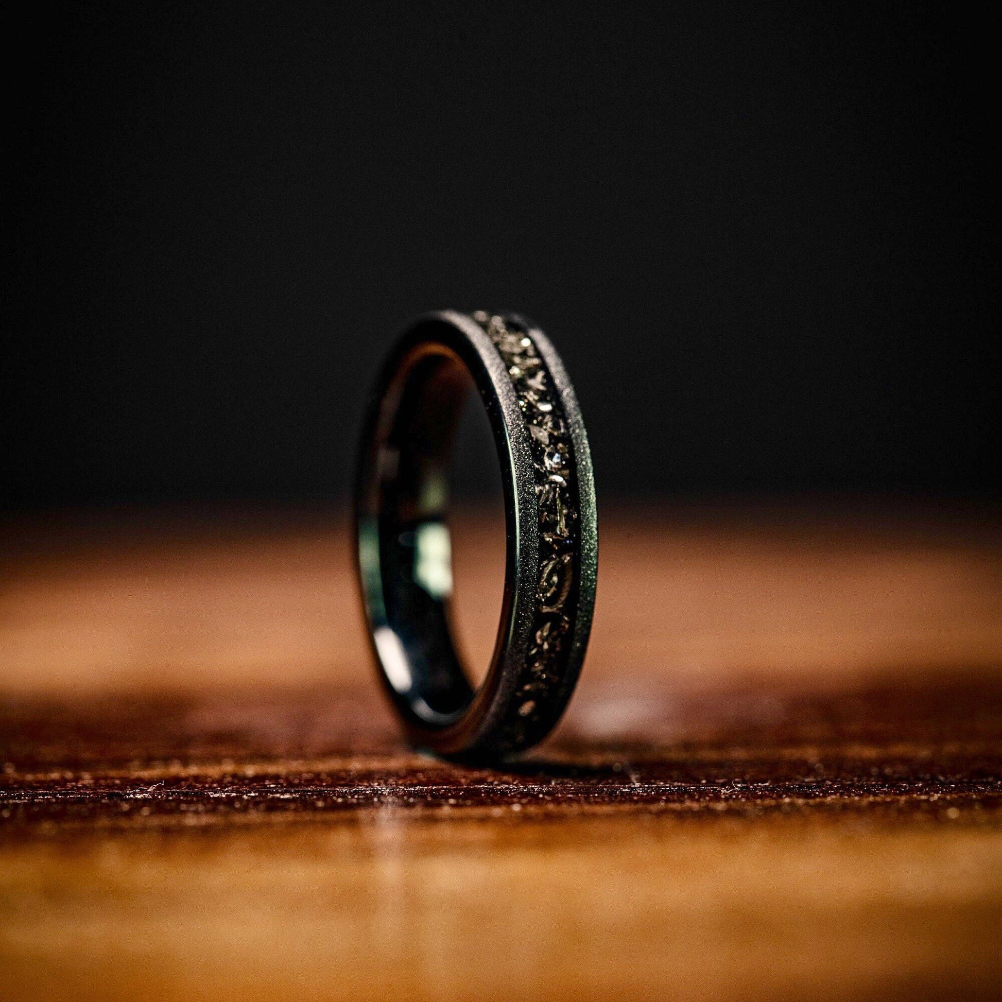 Elegant wedding ring set showcasing real meteorite and black sandblasted bands for couples.