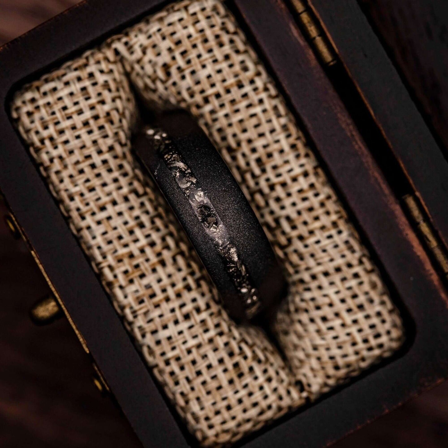 Distinctive his and hers wedding rings with real meteorite and black sandblasted finish.