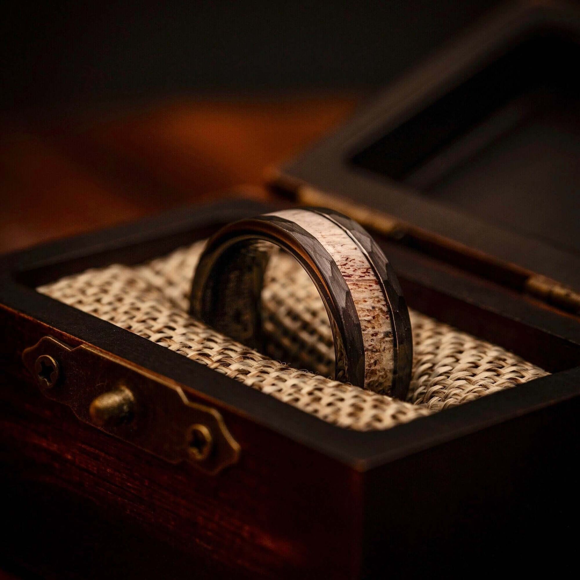 Rustic men's wedding band with hammered texture and authentic deer antler.