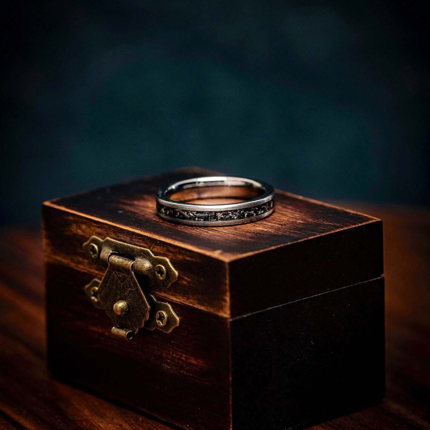 Unique silver engagement ring adorned with real meteorite, symbolizing everlasting love.