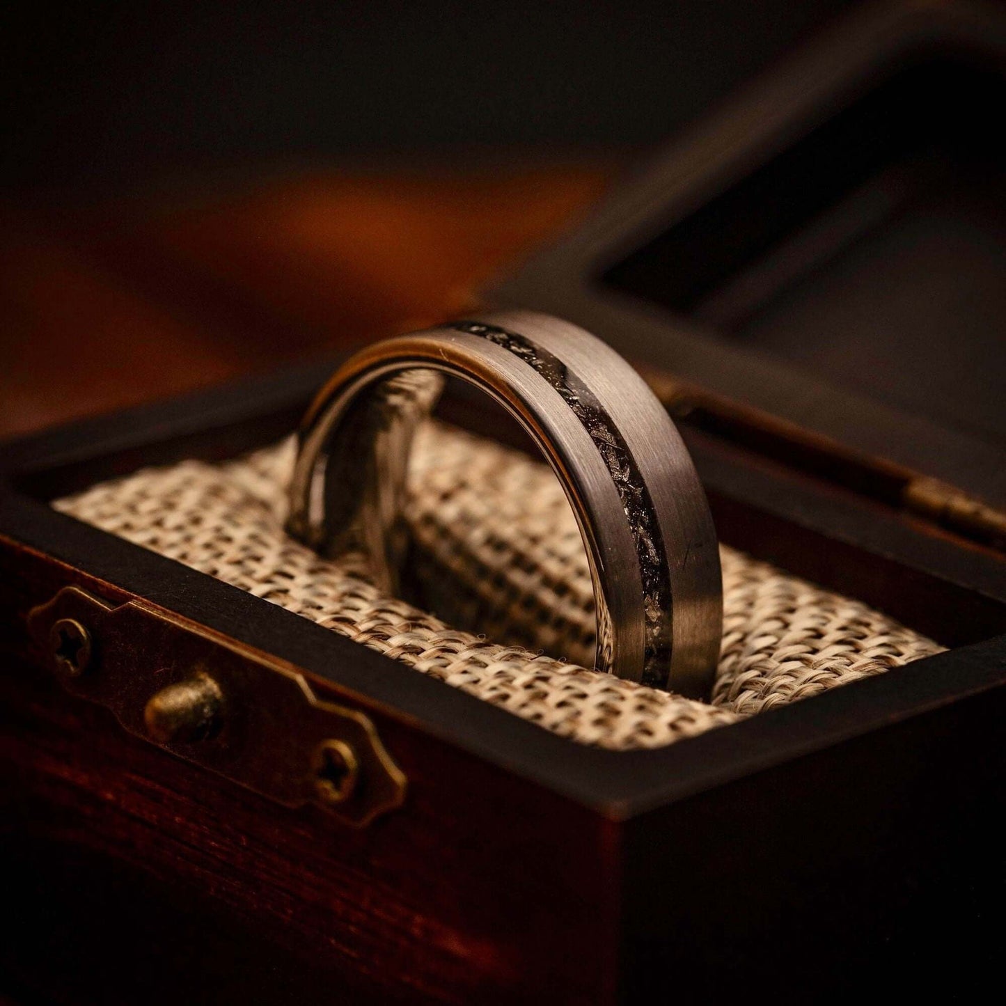 Striking silver engagement ring adorned with real meteorite, symbolizing eternal love.