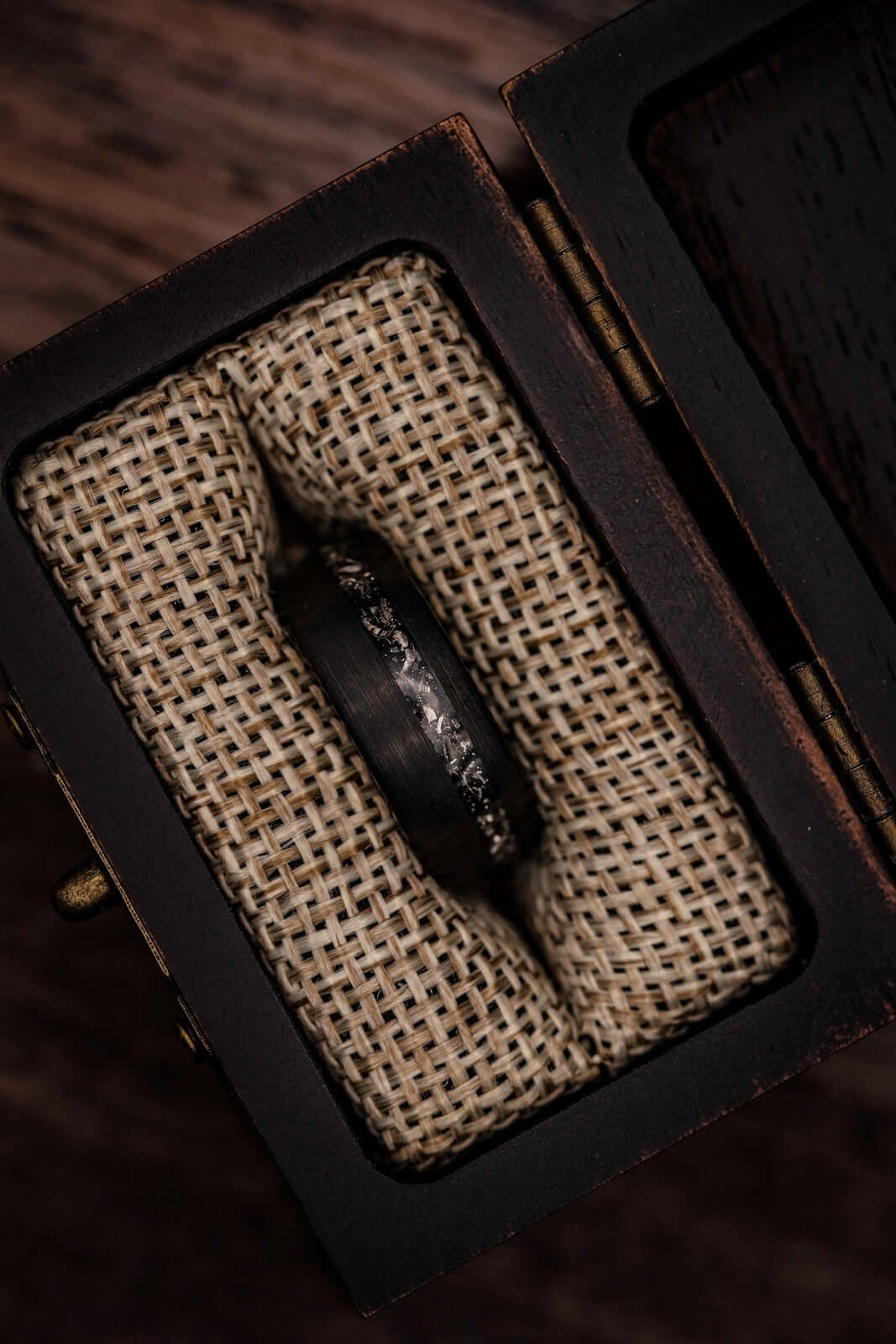 Unique brushed black ring with authentic meteorite inlay, ideal for weddings.