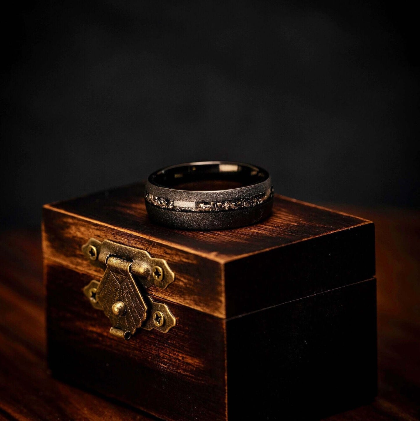 His and hers wedding bands featuring real meteorite and black sandblasted design.