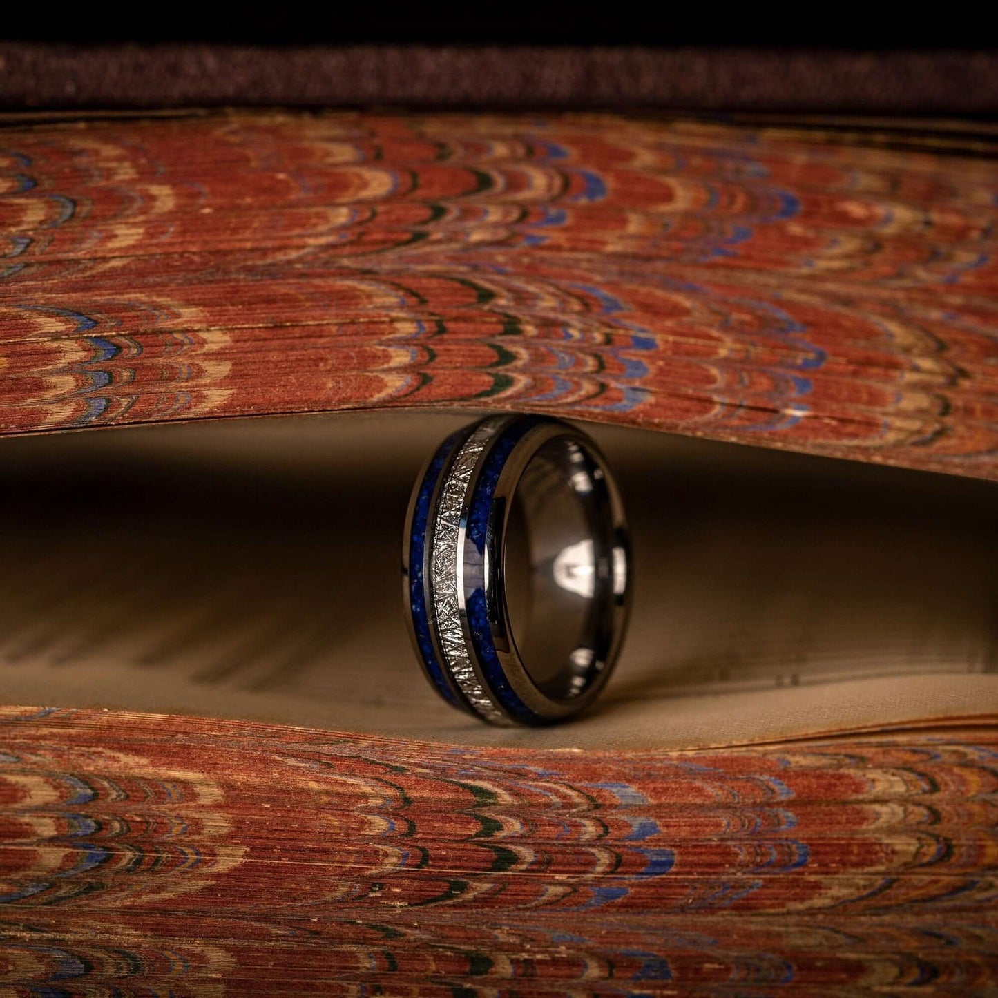Striking men's wedding band crafted from silver with a captivating blue lapis lazuli and meteorite.