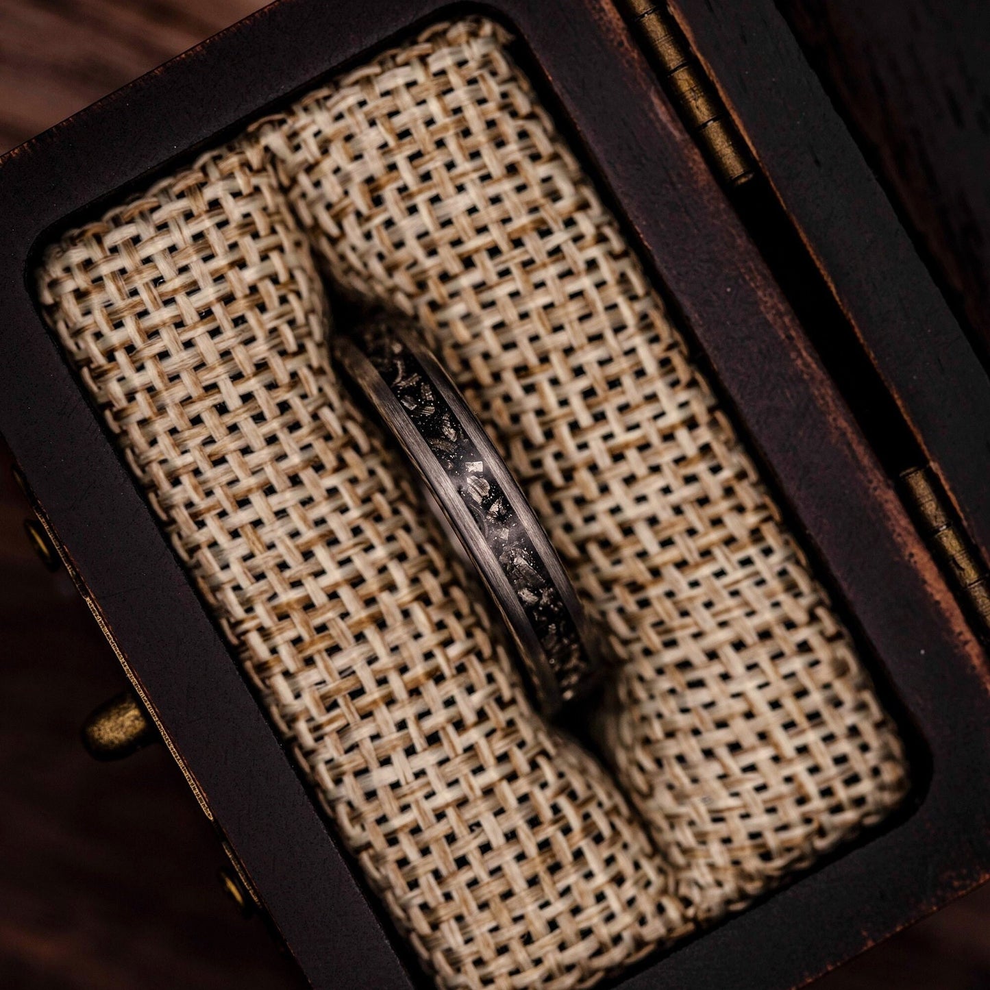 Women's 4mm silver wedding ring with meteorite inlay inside walnut ring box