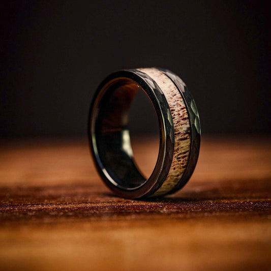 Men's hammered wedding ring featuring real antler, for a rustic touch.