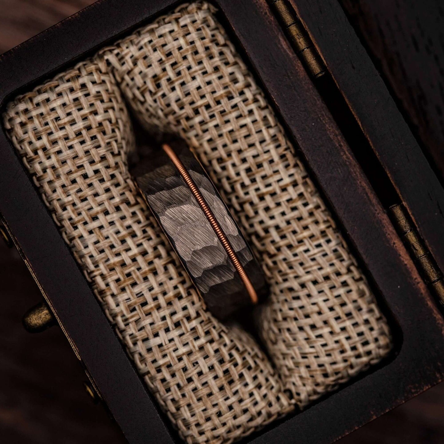 Elegant musician's wedding ring showcasing hammered rose gold, silver, and guitar string motif.