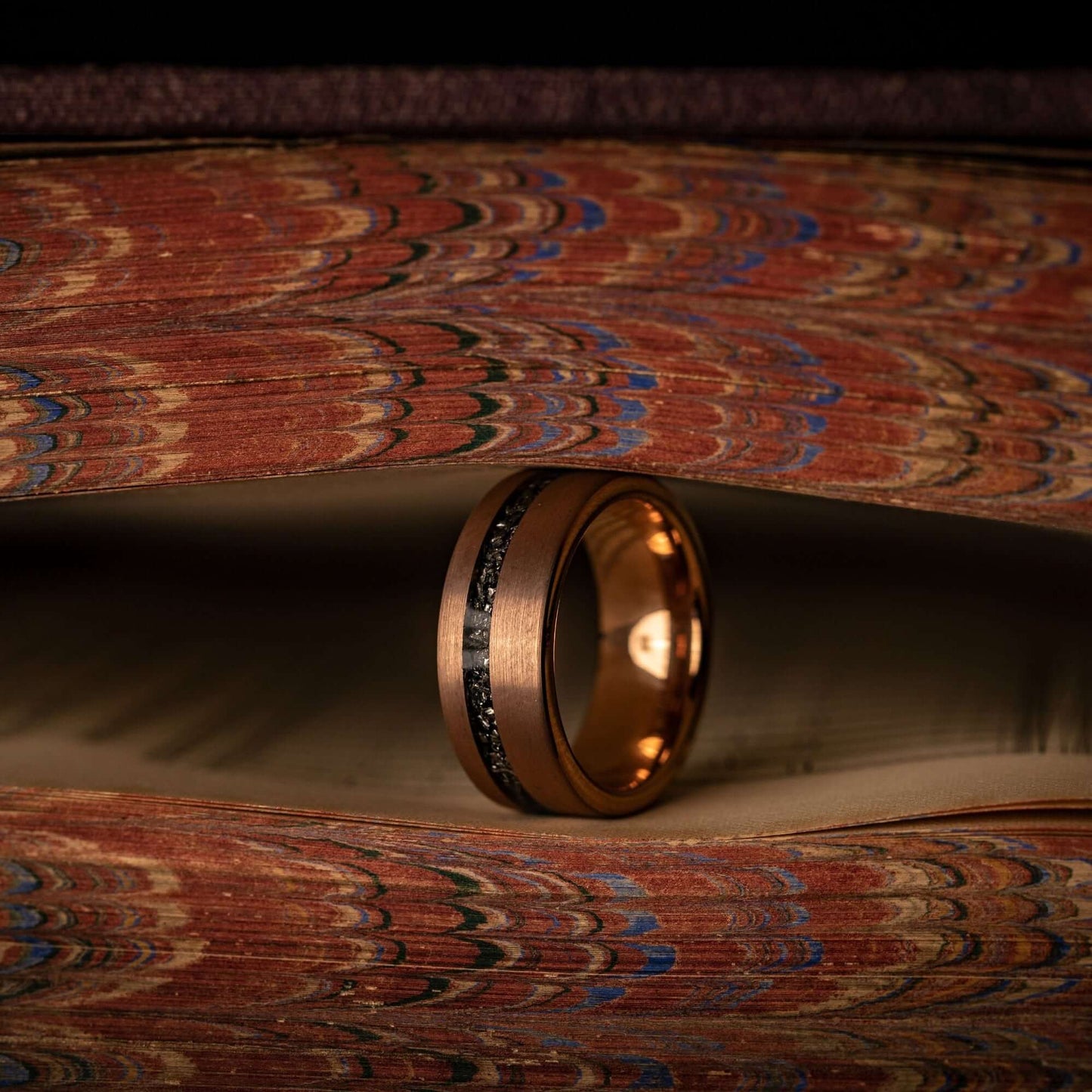 Unique meteorite wedding ring featuring rose gold band, perfect for men's wedding bands.