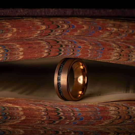 Unique meteorite wedding ring featuring rose gold band, perfect for men's wedding bands.