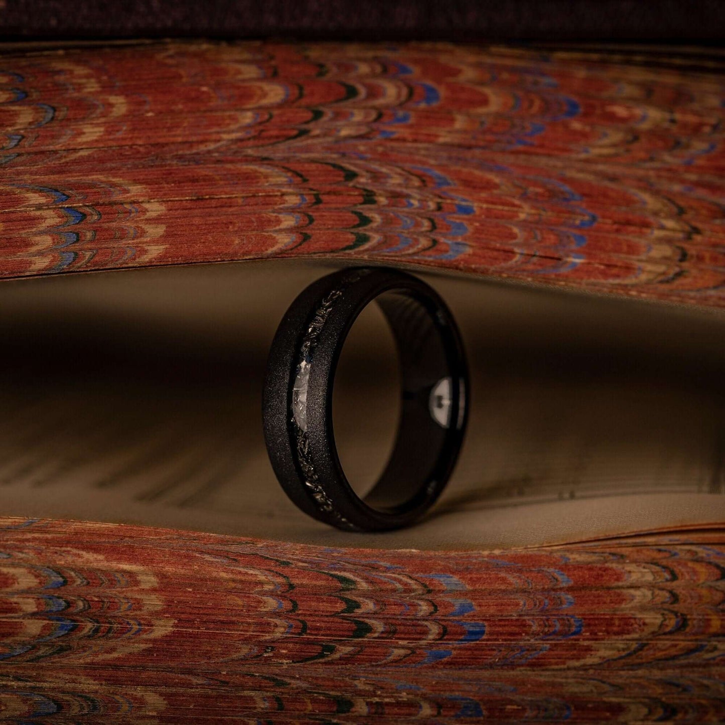 Stylish his and hers wedding bands crafted with black sandblasted and authentic meteorite detailing.