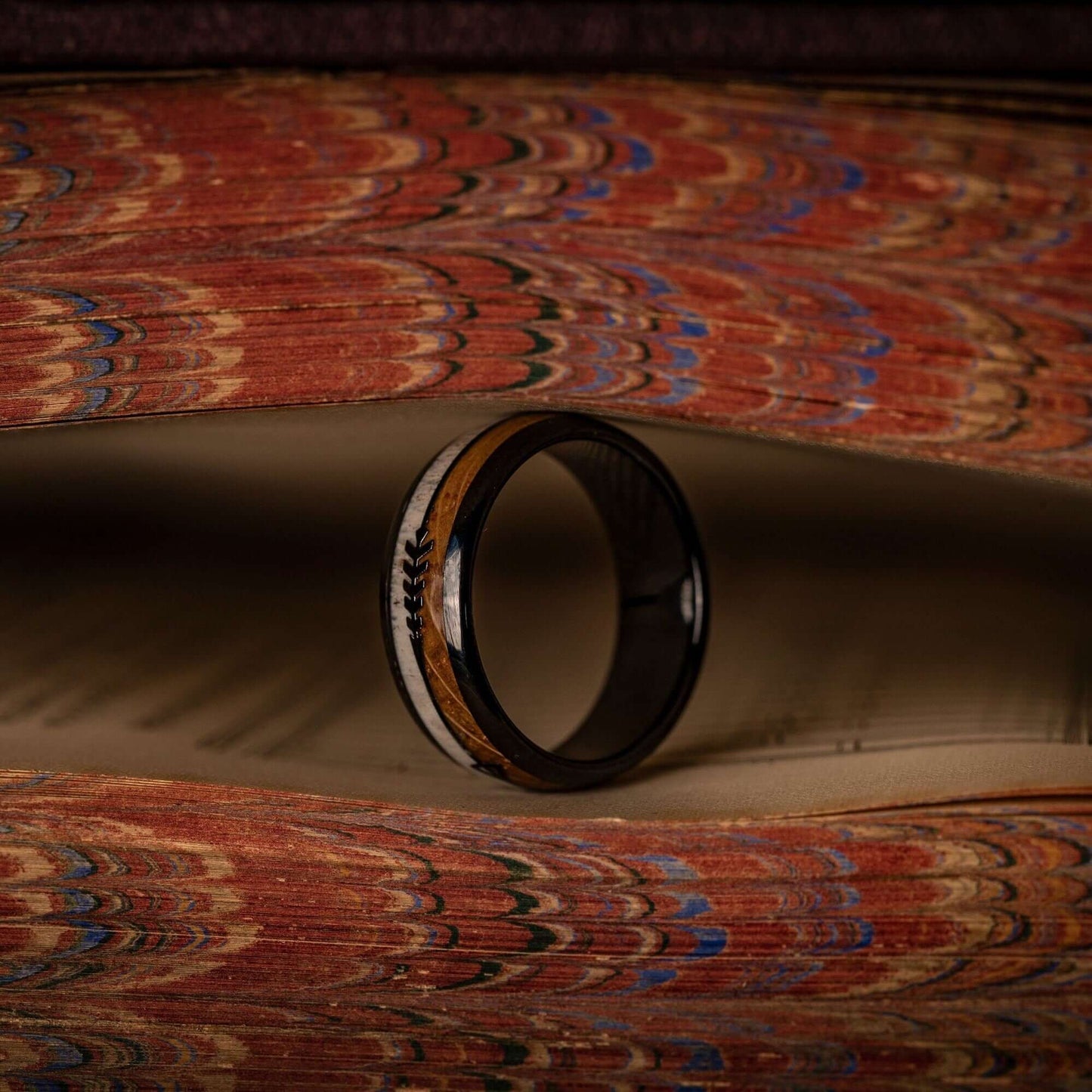 Unique deer antler wedding ring featuring whiskey barrel wood inlay, perfect for nature lovers.