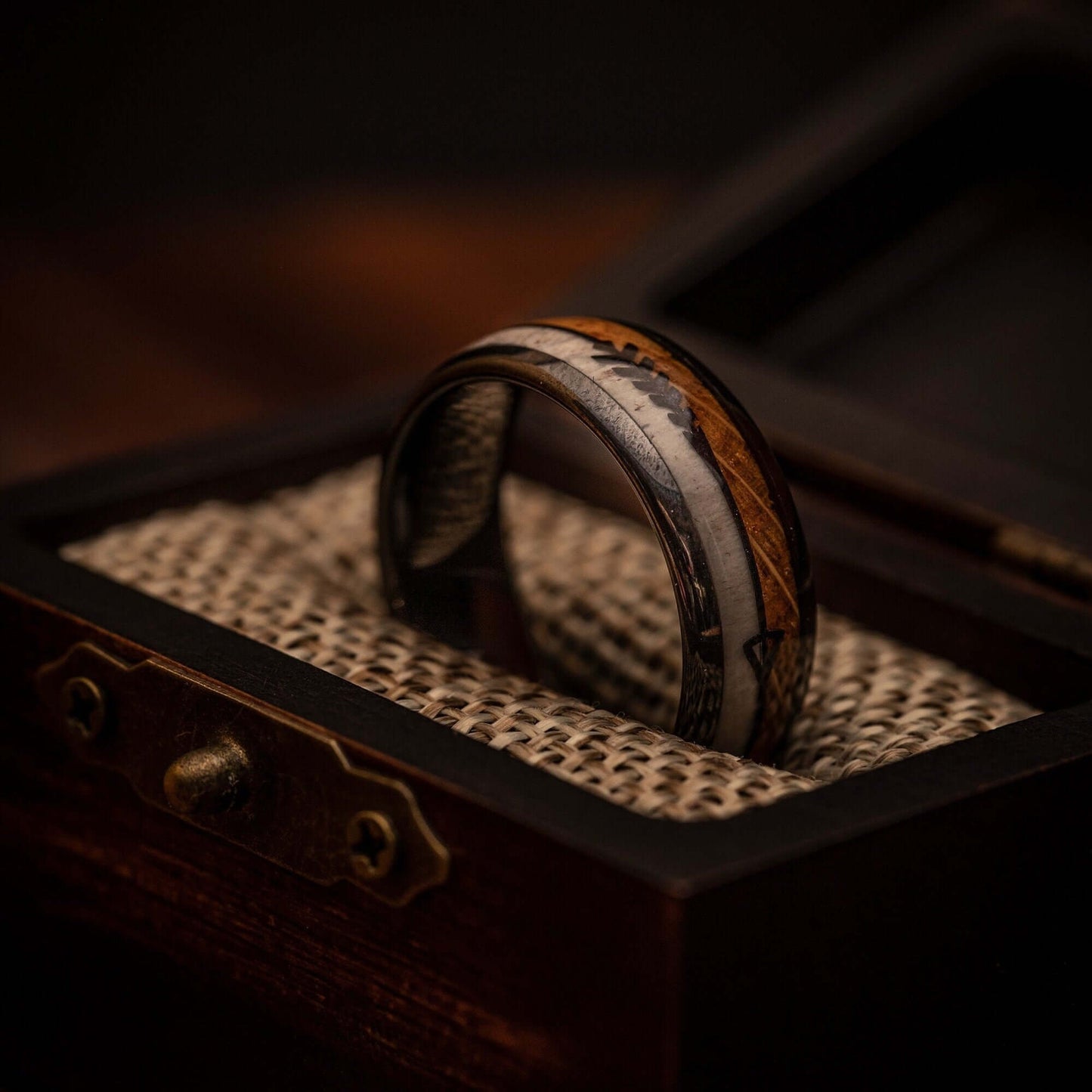 Distinctive men's wedding band showcasing real deer antler and whiskey barrel wood.