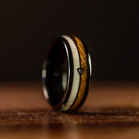 Men's wedding band with deer antler and whiskey barrel wood inlay, offering rustic charm.