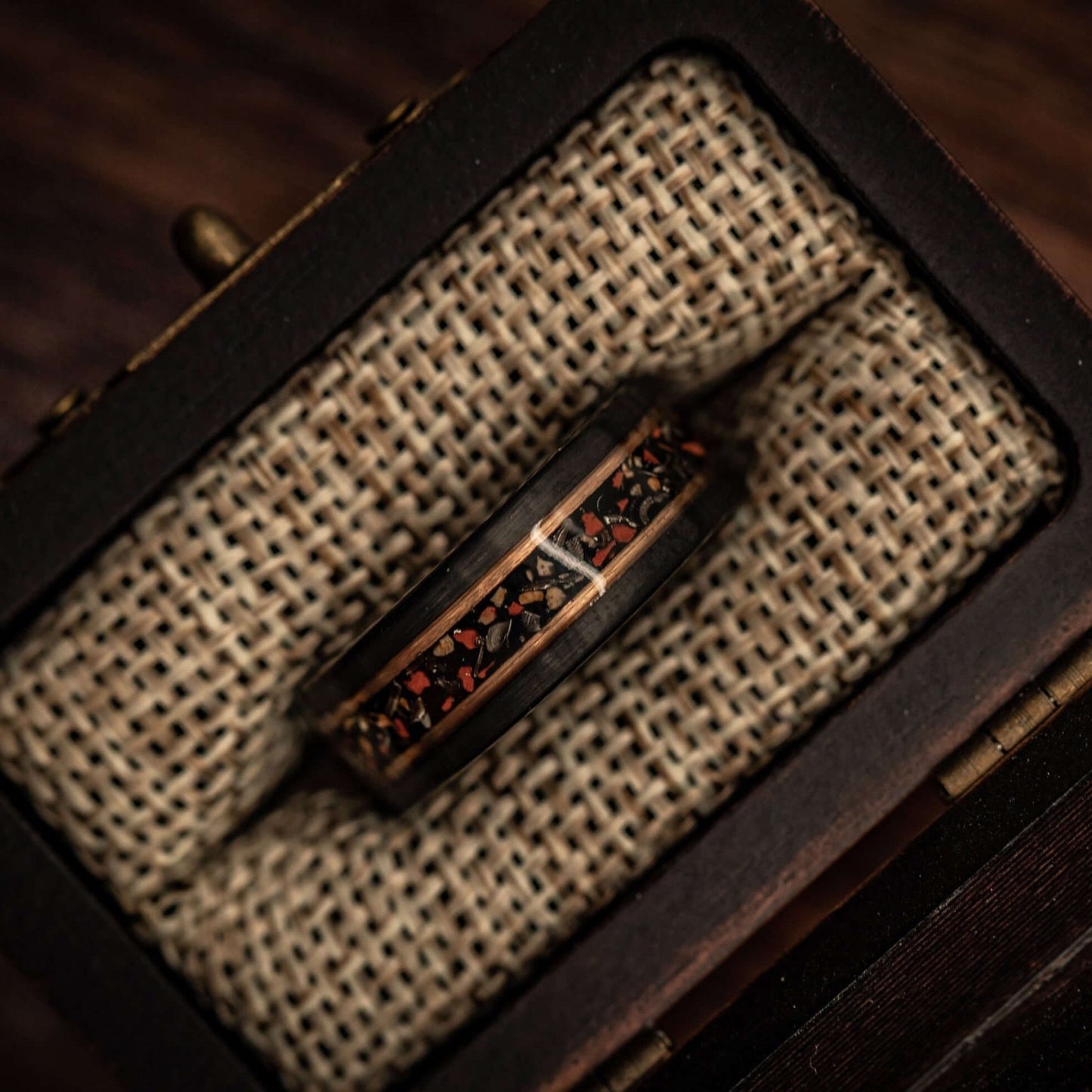 Black Tungsten Wedding Band with Red Dinosaur Bone and meteorite inlay inside walnut ring box