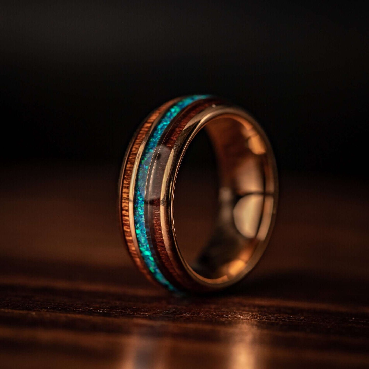 Stylish wedding band showcasing rose gold, Hawaiian Koa wood, and beautiful blue opal.
