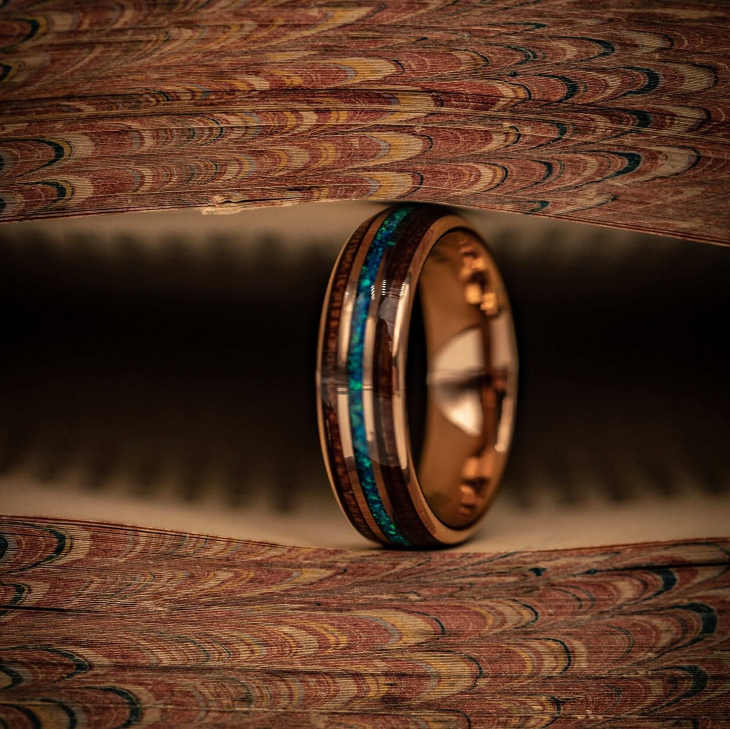 Stylish wedding band showcasing rose gold, Hawaiian Koa wood, and beautiful blue opal.
