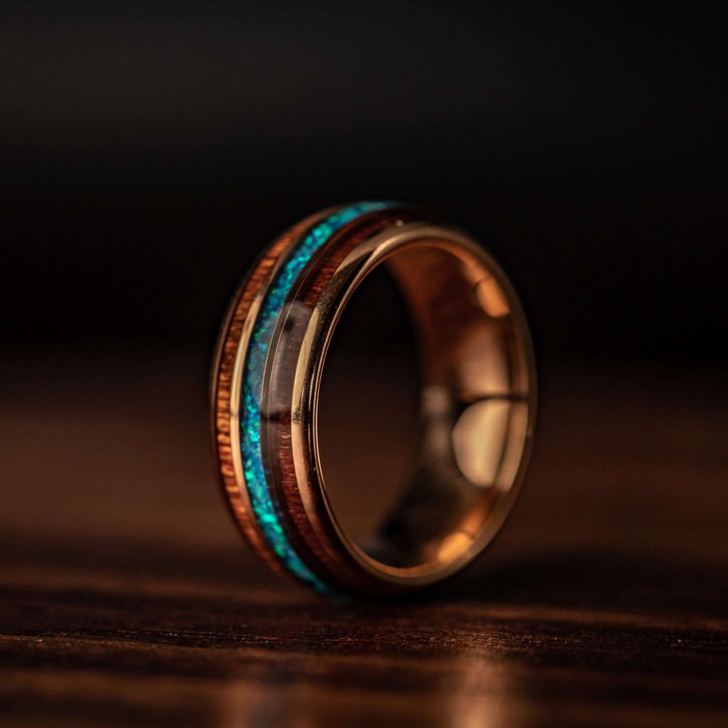 Unique rose gold ring with Koa wood and vibrant blue opal, perfect for weddings.