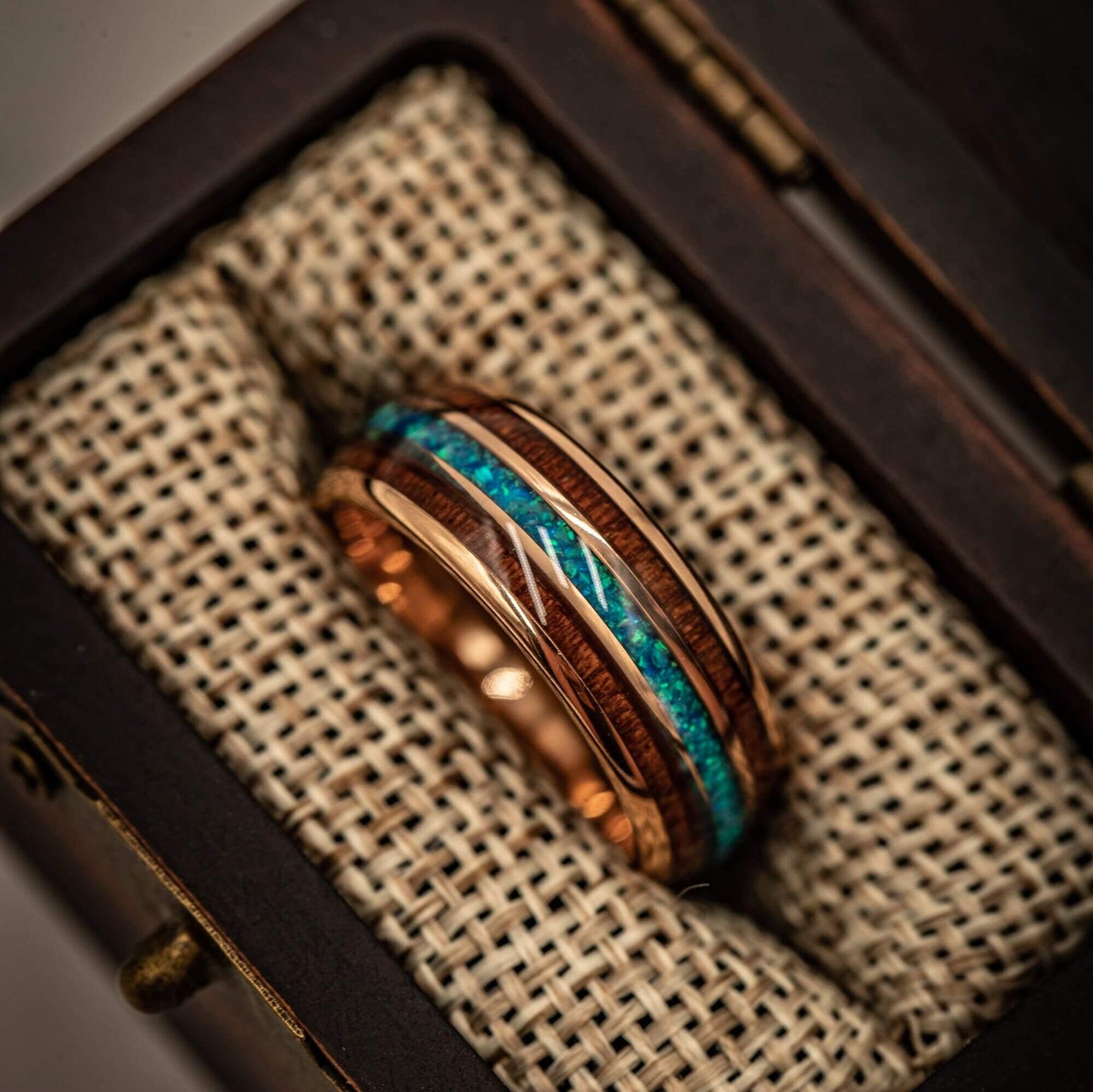 Rose gold ring featuring 8mm width, Koa wood, and striking blue opal detail.
