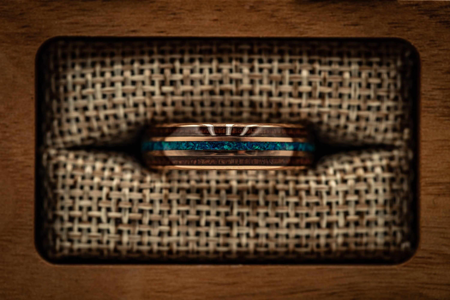 Distinctive 6mm wedding band crafted with rose gold, Koa wood, and blue opal.