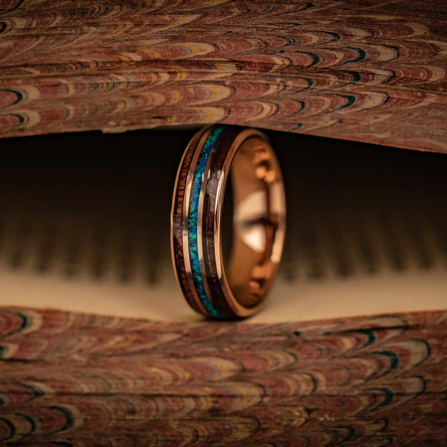 Unique rose gold ring with Koa wood and vibrant blue opal, perfect for weddings.