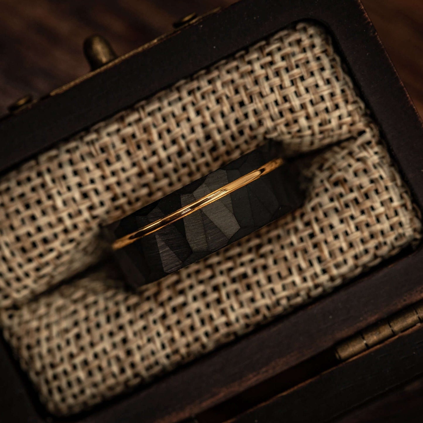 Hammered Black Tungsten Wedding Ring with Polished Rose Gold Inner Band inside walnut ring box