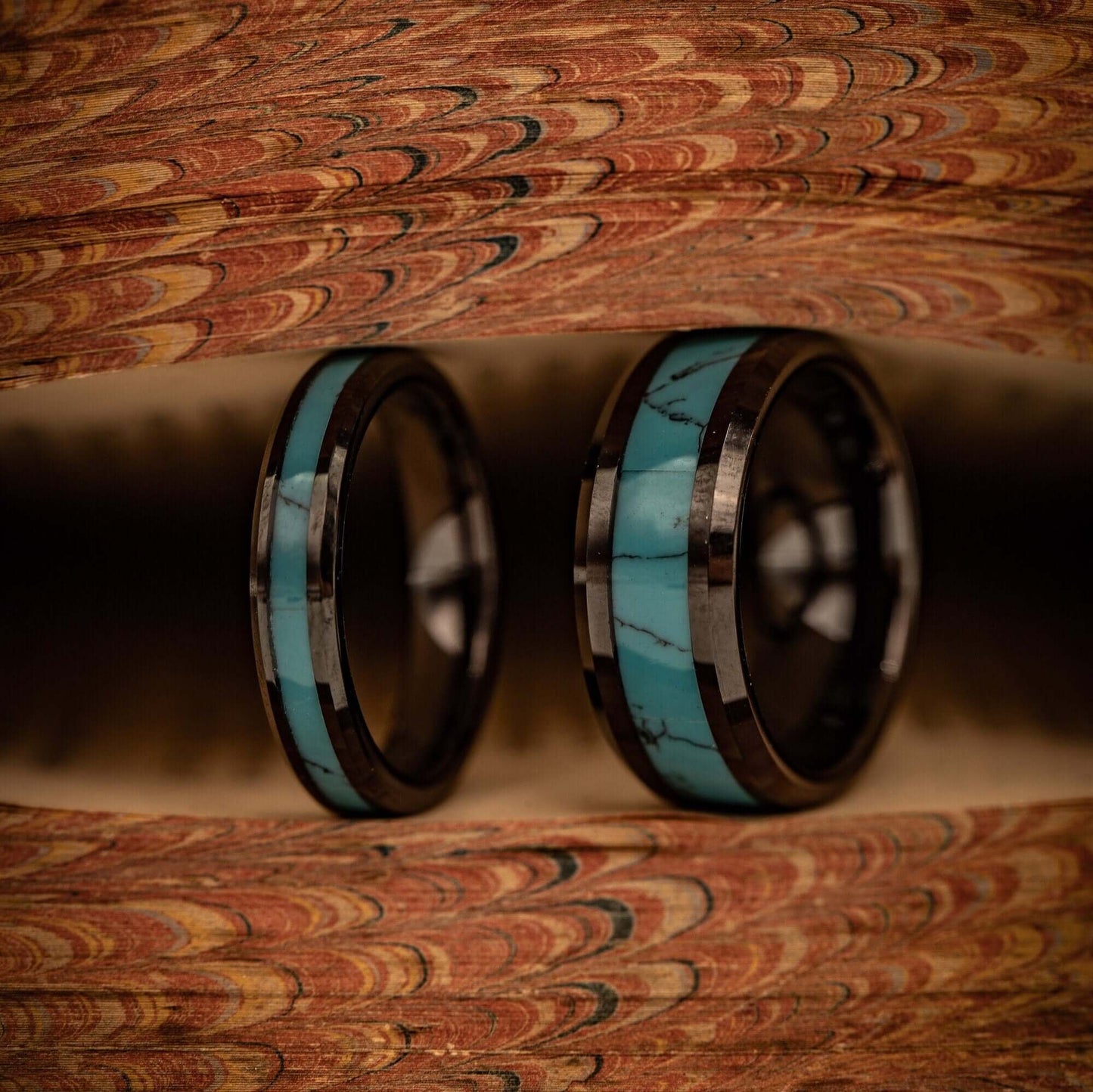 Men and womens wedding rings both black rings with turquoise inlay