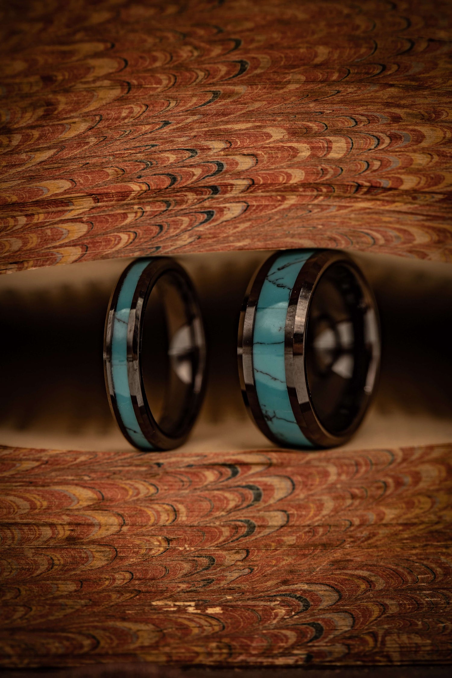 Unique handcrafted turquoise rings with meteorite inlays displayed on an ornate background. Perfect for weddings, engagements, or daily wear.