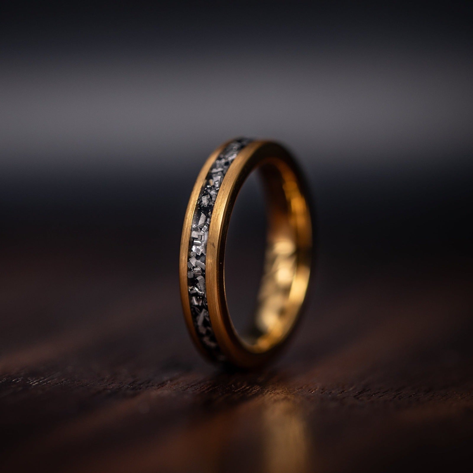 Womens 4mm yellow gold ring standing on edge