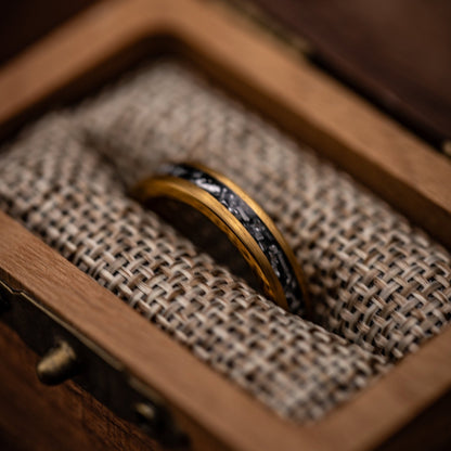 Stunning gold and meteorite wedding bands for him and her, perfect for exchanging vows.