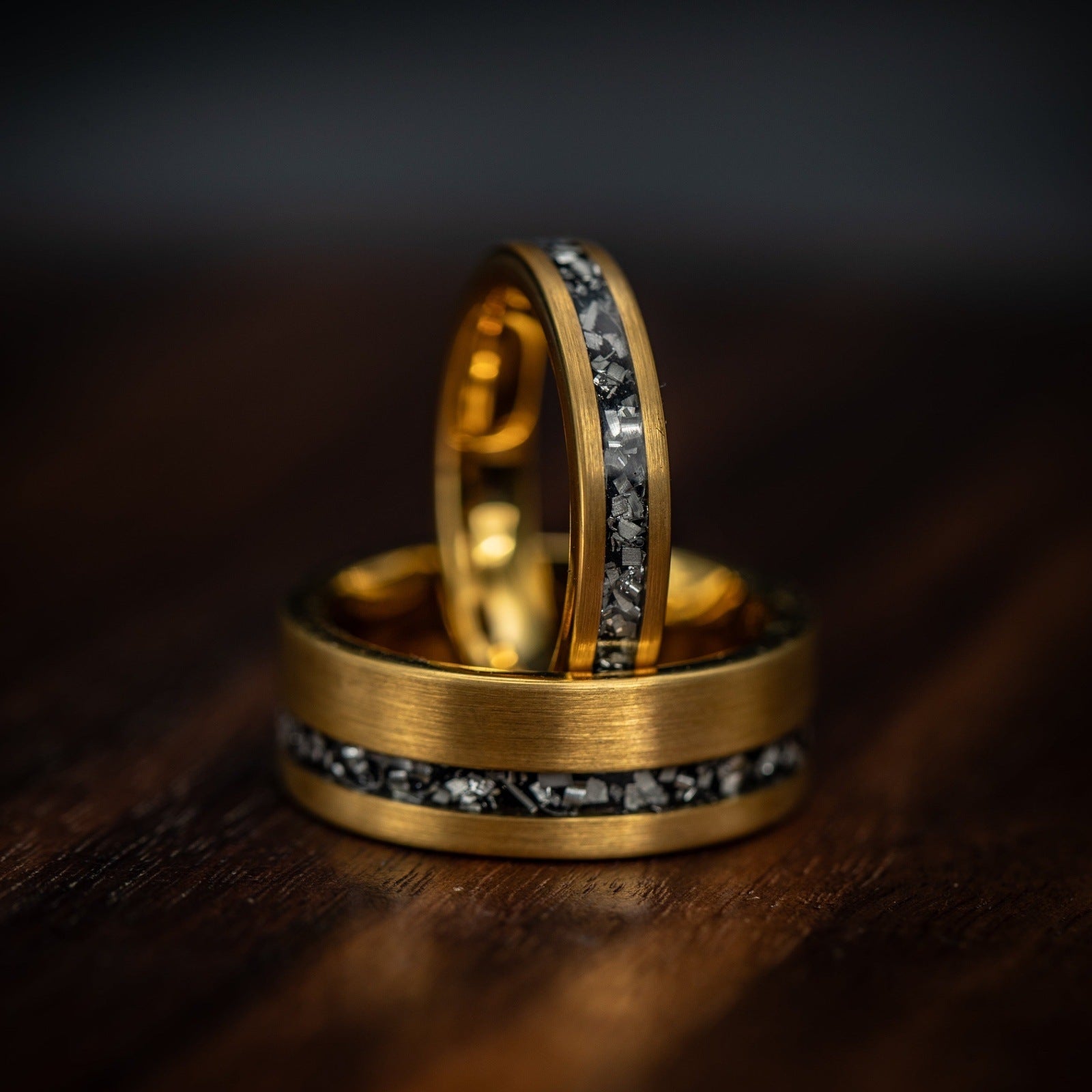 Matching his and hers yellow gold meteorite wedding rings, symbolizing everlasting love.