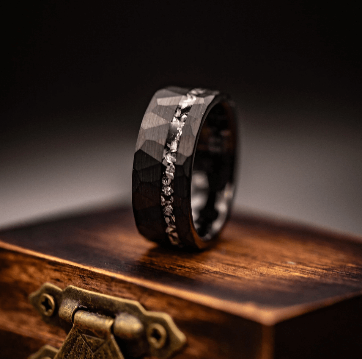 Bold men's meteorite wedding band with a hammered finish, symbolizing strength and resilience.