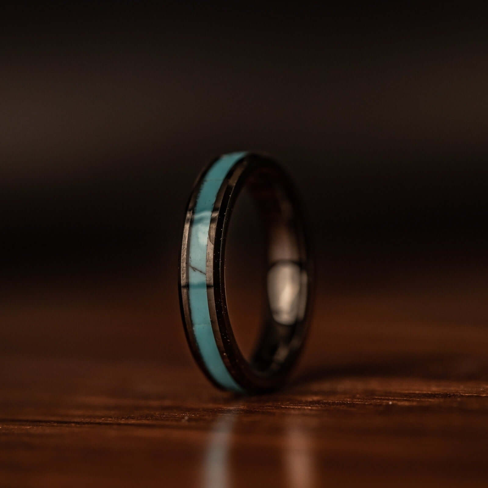 Stunning turquoise and black wedding ring duo, perfect for your special day.